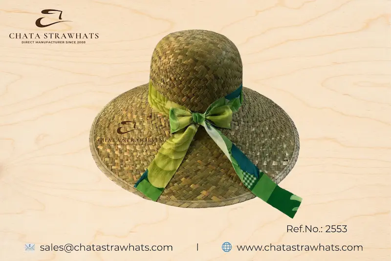 Ladies’ seagrass straw hat with green patterned ribbon and wide brim